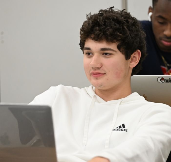 student in class with laptop
